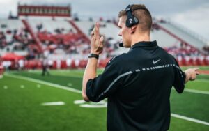 An athletic personnel talking through radio headphone